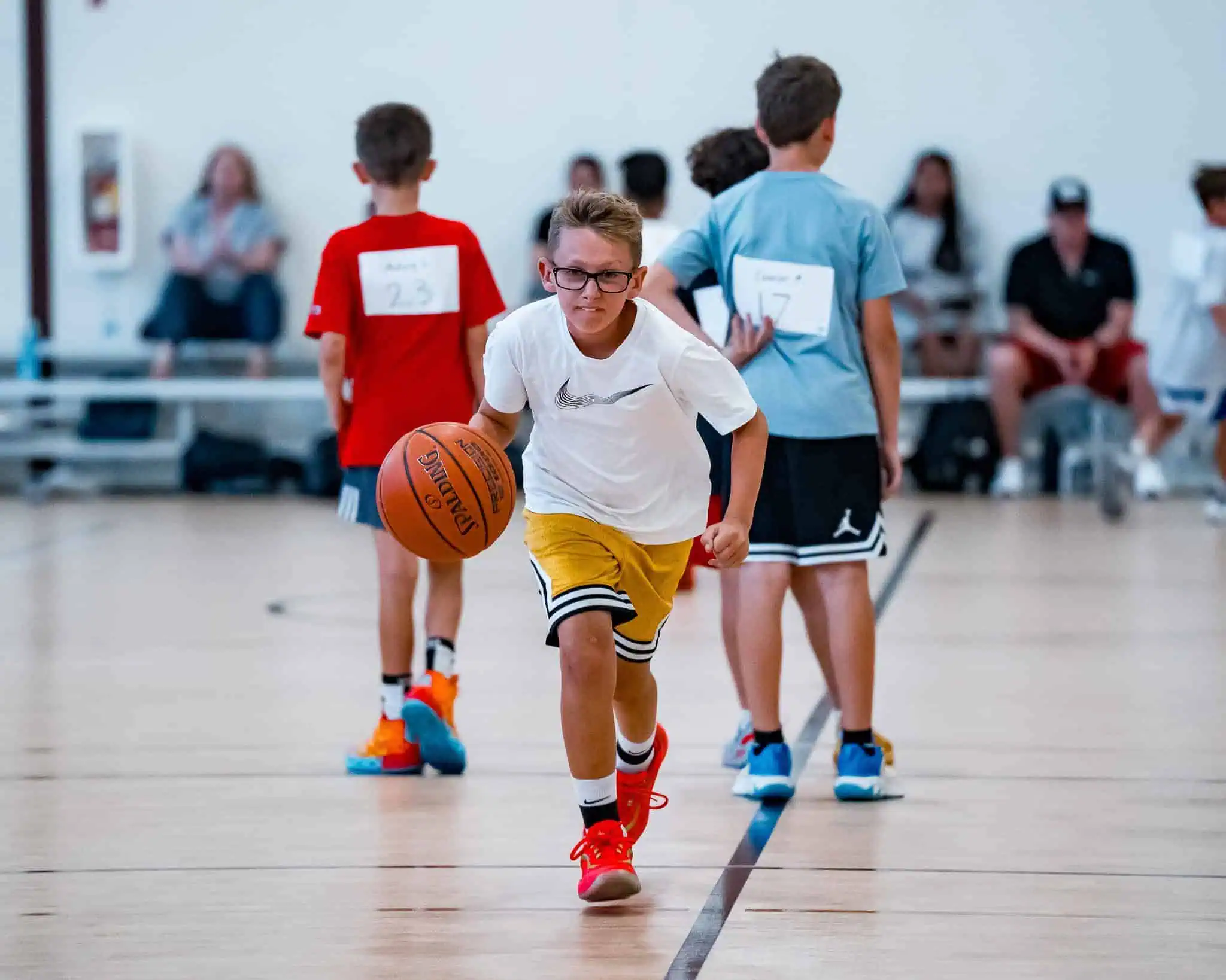 Young basketball player practicing basketball drills during training